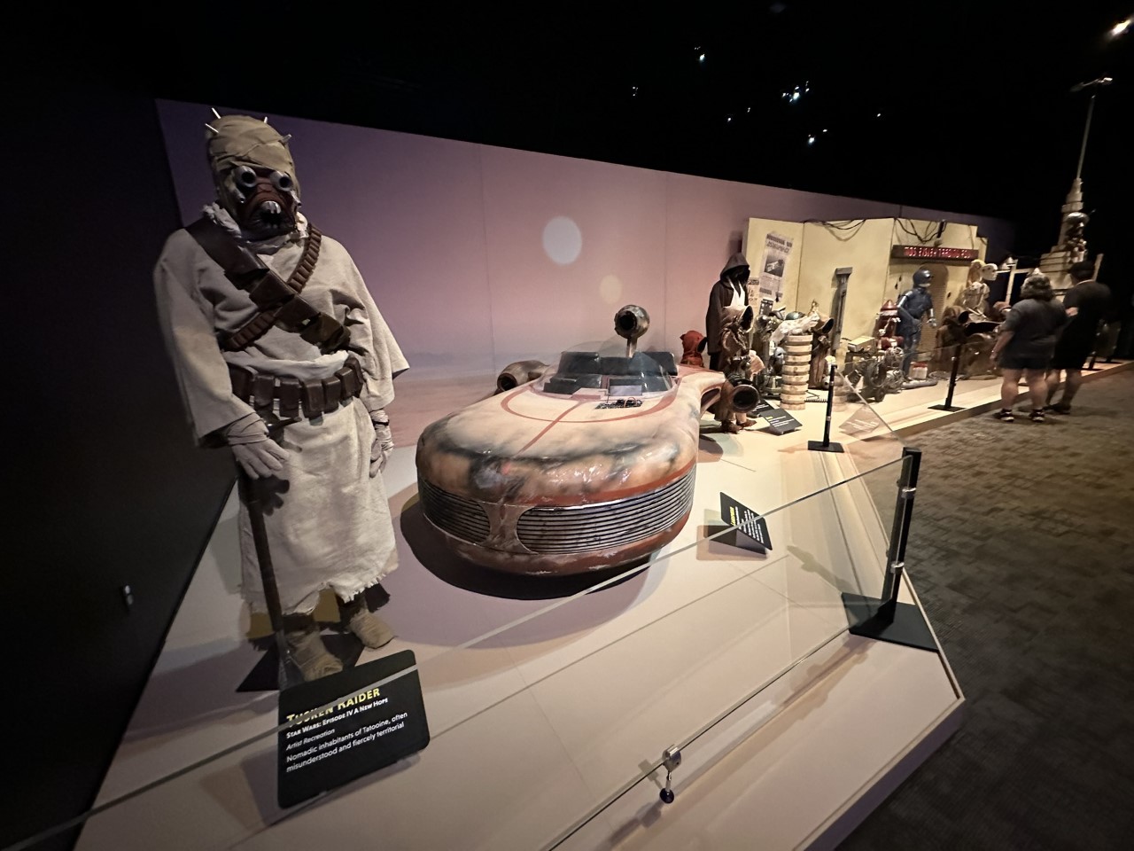 Tusken Raider costume displayed with Luke Skywalker's landspeeder from Tatooine