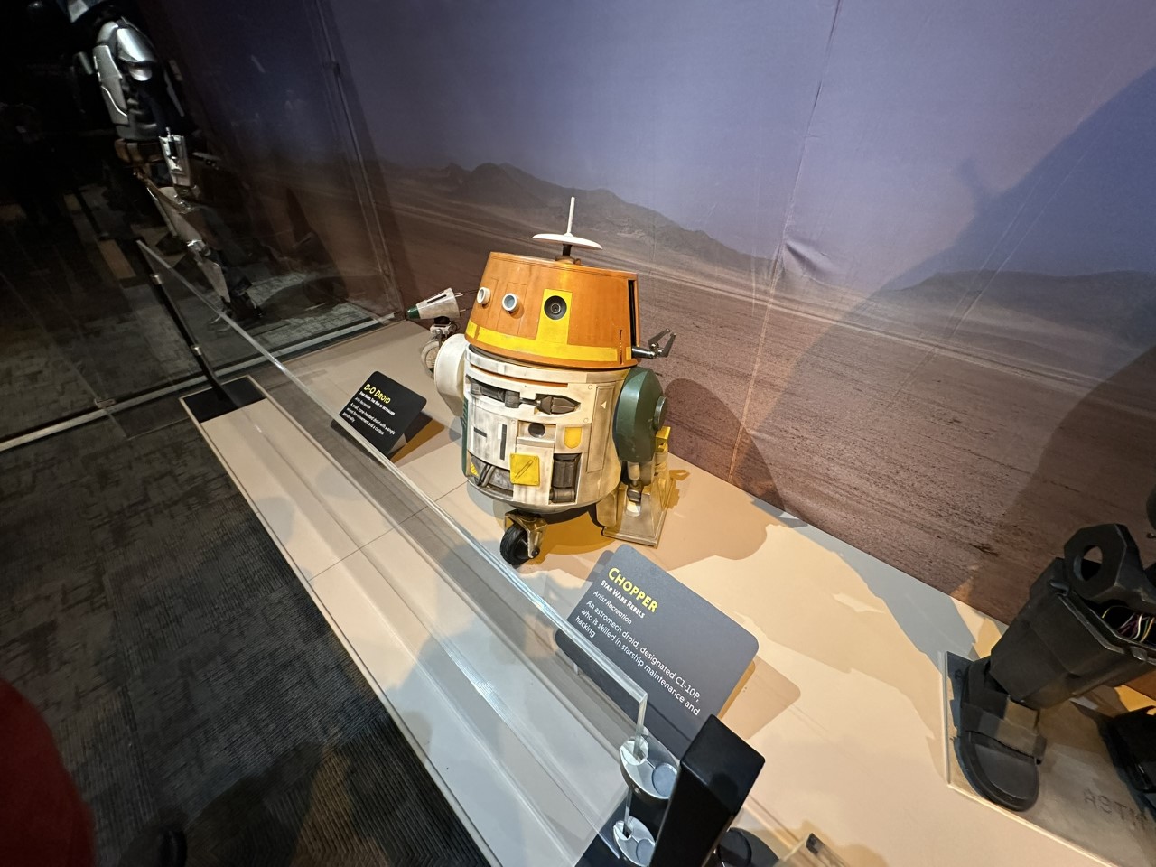 Chopper astromech droid from Star Wars Rebels displayed with desert planet backdrop
