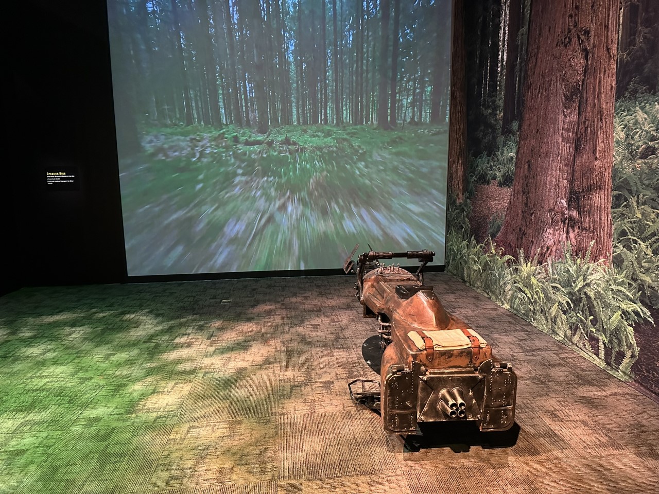 Imperial speeder bike display with immersive forest chase projection from Return of the Jedi