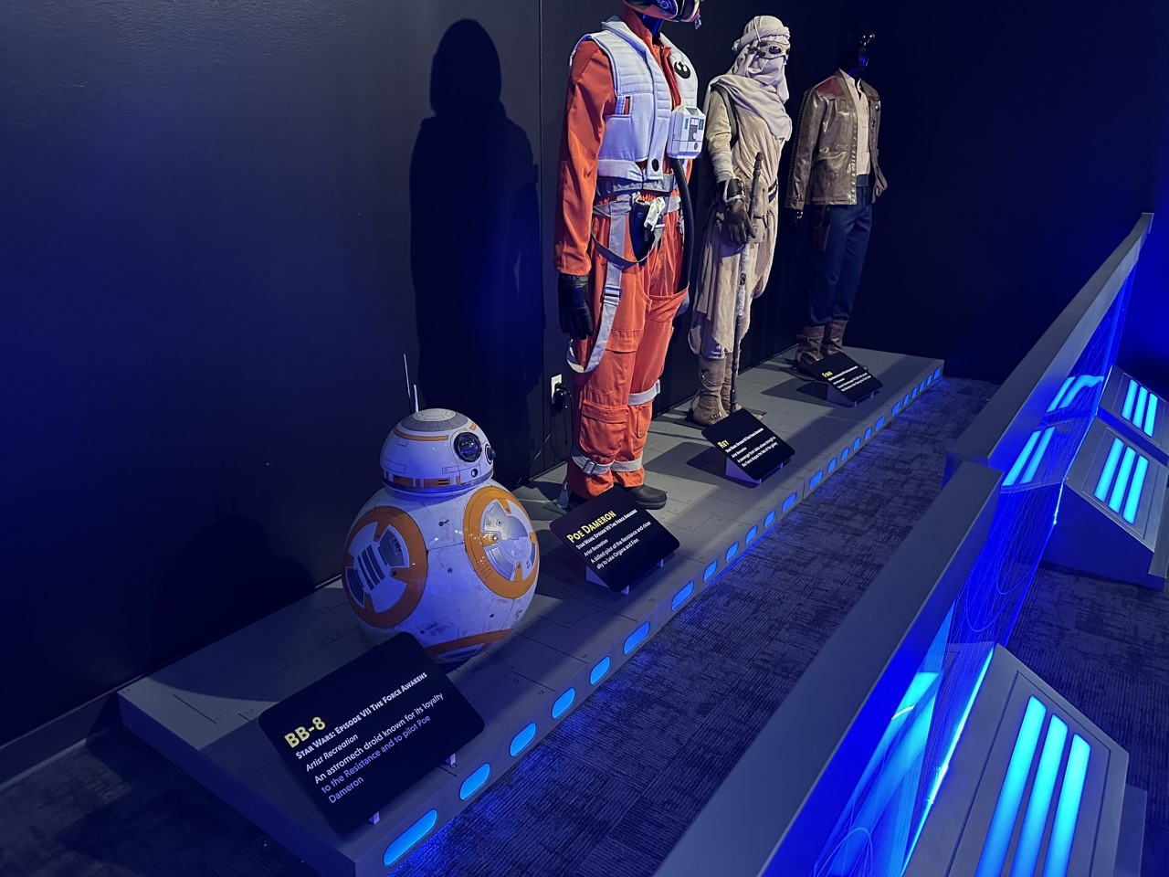 BB-8 droid with sequel trilogy costumes including Poe Dameron's pilot suit and Rey's scavenger outfit